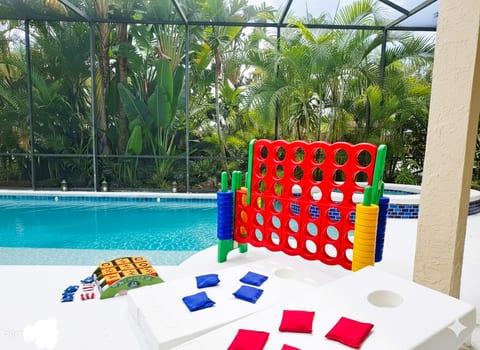 Poolside playtime just got an upgrade! From giant Connect 4 to Cornhole, the fun never stops in our bug-free, screened-in oasis. Who's ready to play? ☀️ #PoolsideGames #FamilyFun