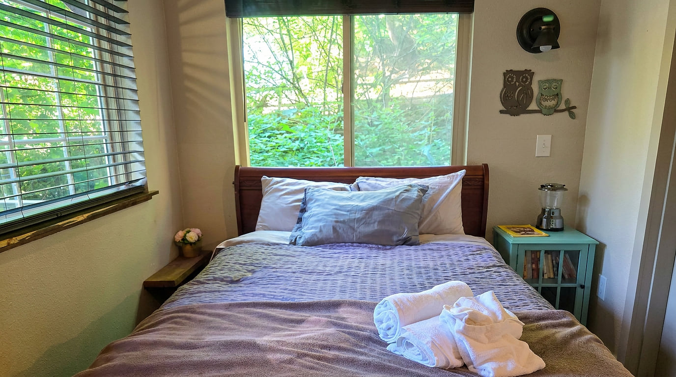 Cozy garden-view bedroom with natural light and inviting decor