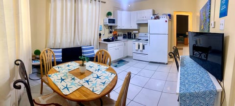 Open living and kitchen area with dining for up to 4 — fully functional for longer stays.