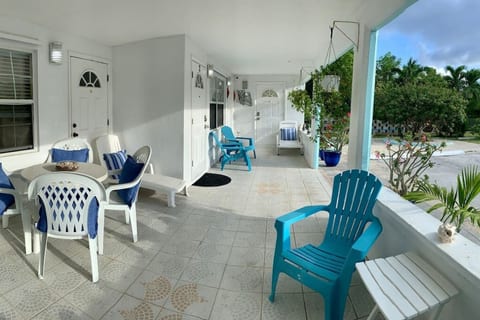 Front porch, with deck chairs & sun loungers. Dining table has been replaced with a 9-foot solid wood outdoor table with 6 chairs!