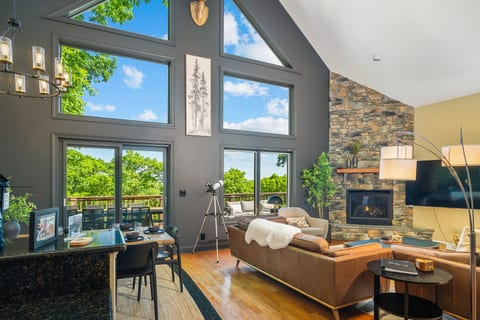The main level opens wide for shared meals, fireside lounging, and treetop & distant views all in one easy flow.