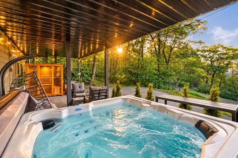 Covered hot tub and cedar sauna for year-round relaxation with filtered mountain views. Cozy, dry, and peaceful - this lounge is perfect place to unwind, even on rainy days