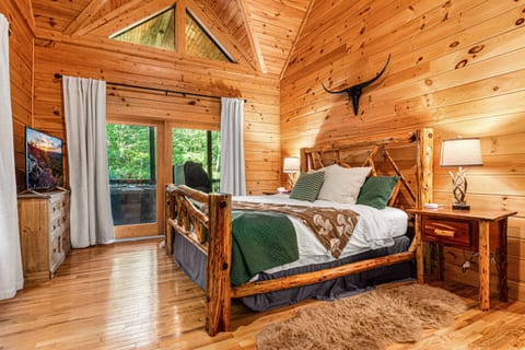 Primary bedroom with custom log king bed and nightstands. All beds include fresh and extra soft linens for an ultimate night's sleep!