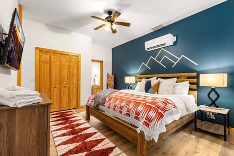 Extra spacious third bedroom with a king bed and exterior access to the backyard and access to a full bathroom.