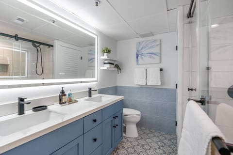 Striking tile, double vanity, ample storage, and an illuminated LED mirror enhance functionality and style.