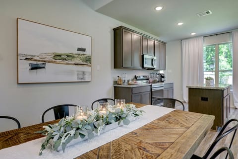 Elegant yet casual dining space showcasing a sturdy plank-top table, black metal seating, and gentle natural light.