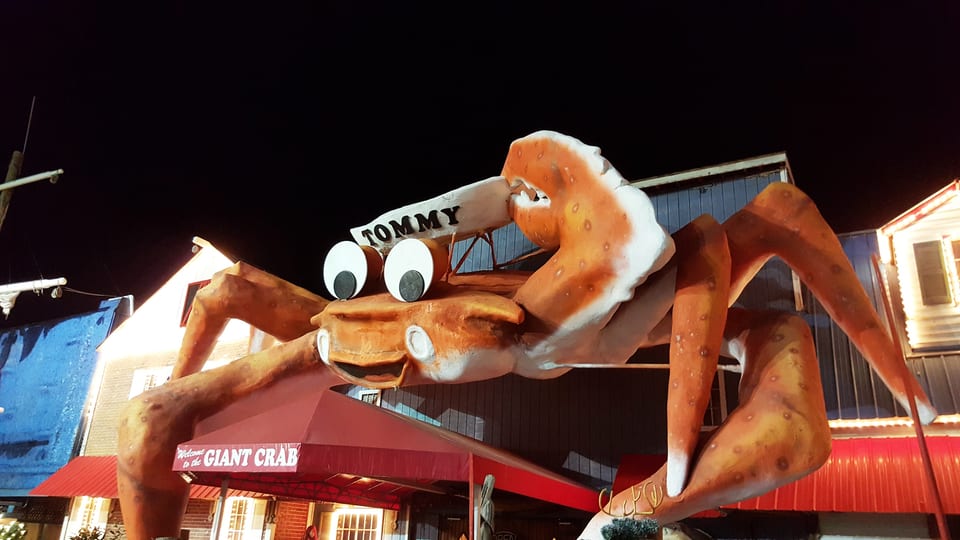Giant, cheerful crab statue towers over the entrance, inviting seafood lovers to Giant Crab restaurant.