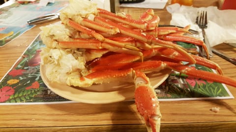 A mouthwatering pile of freshly steamed crab legs promises a feast at Giant Crab.