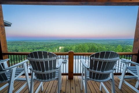 Forest-view deck with Adirondack chairs at sunset, Broken Bow, OK.