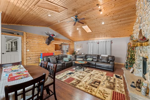 Cozy cabin great room with stone fireplace and spacious sectional