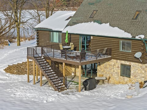 Spacious log cabin deck with snowy views and cozy outdoor seating