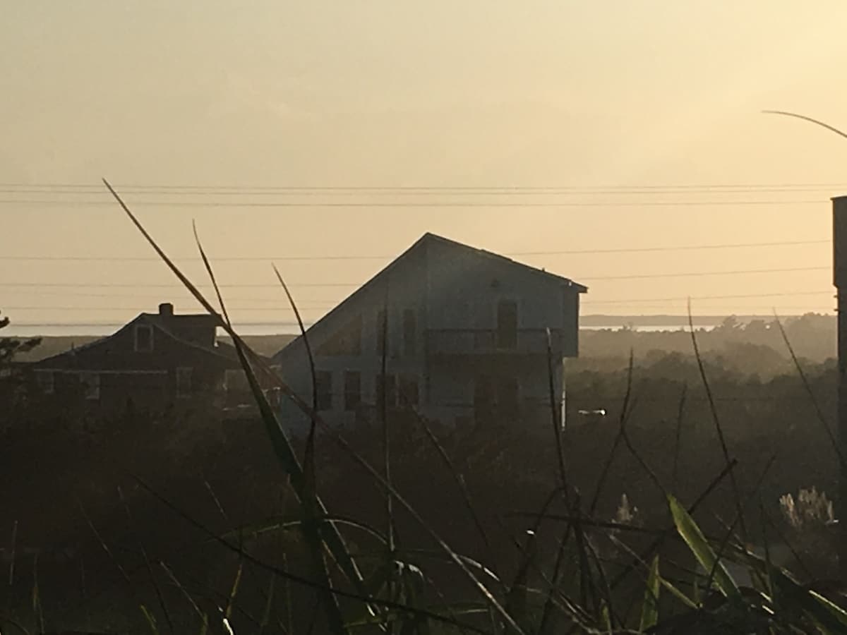 Sunset view of the house from the dune at the beach,  sound and ocean views!