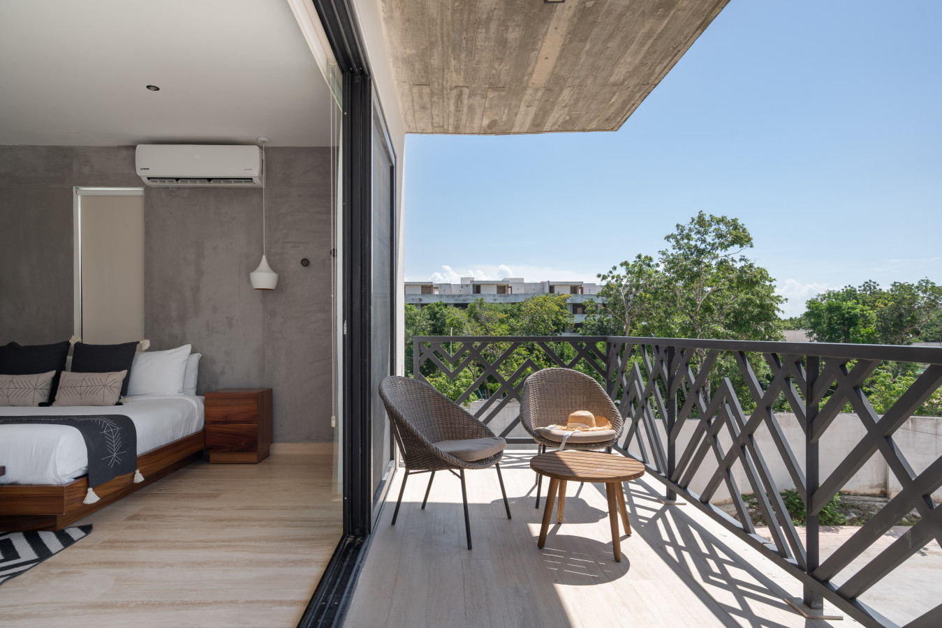 Private balcony with modern seating surrounded by greenery — perfect for relaxing, enjoying a drink, and soaking in the calm tropical ambiance