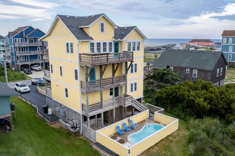 Rear view of Atlantic Dreams with private pool and chaise loungers, multiple decks with ocean and spectacular Pamlico Sound views, and easy access between the Game Entertainment Floor and private pool.