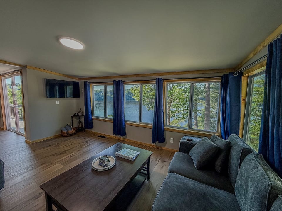 Cozy lakeview living room with panoramic windows and relaxing seating