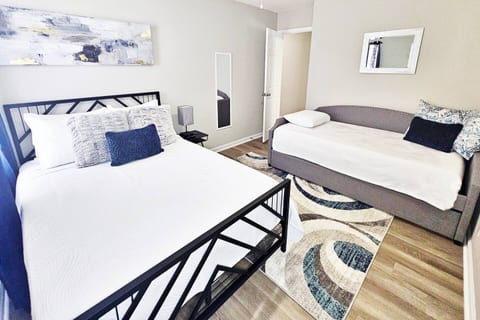 This serene bedroom can sleep up to 4 adults. Full-length mirror and flat screen smart TV in here as well!