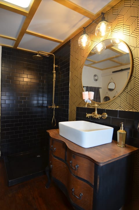 Brand new classic eclectic full-sized bathroom with large custom-crafted vanity and walk-in closet attached