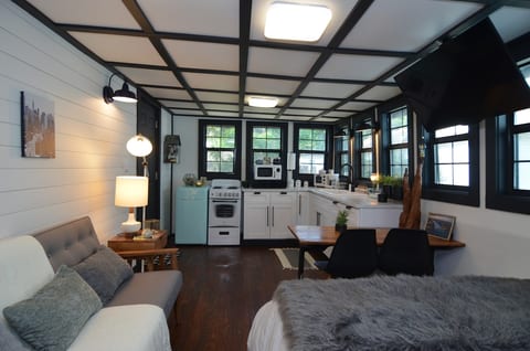 Brand new high-end Tiny Home! Beautiful kitchen with touches of classic and modern style. Fully functional and stocked with dishes and necessities. All windows have 2" blinds per later photos.