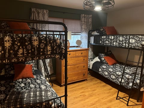 Bed 3: Two bunk beds, dimmable ceiling fan, blackout shades, tall dresser, closet, luggage rack, usb charger, door to 1/2 bath