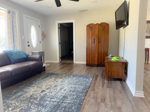 This room is adjacent to living room, but has no doors or closet. I have an empty armoire and a queen sofa bed and tv