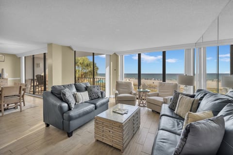 Spacious living area with panoramic Gulf views and plush seating for the whole family
