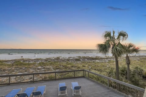 Unwind on the private deck with stunning Gulf sunsets and sugar-white sand just steps away