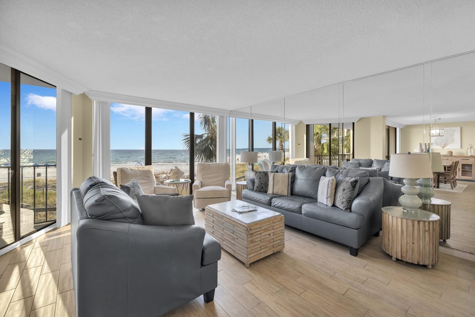 Spacious living area with panoramic Gulf views and plush seating for the whole family