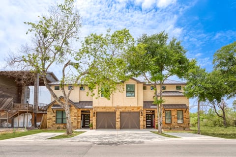 Modern duplex with garages, shaded drive, and tranquil setting