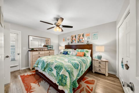 Master Bedroom: Relax in this tropical-inspired master suite with king bed, cozy lighting, and direct balcony access