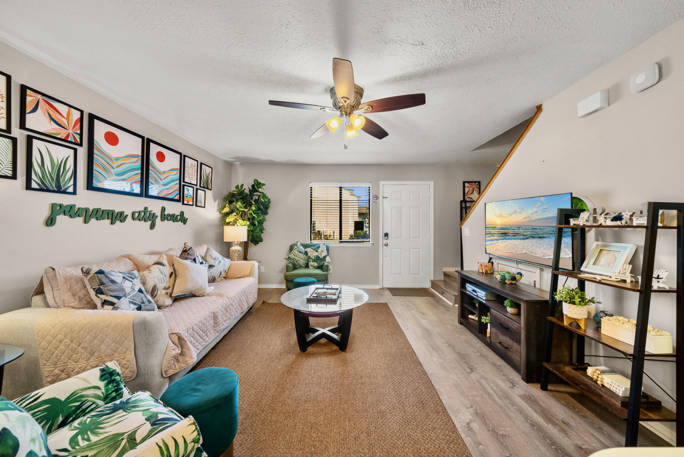 Spacious living room with Smart TV, tropical décor, and plenty of natural light