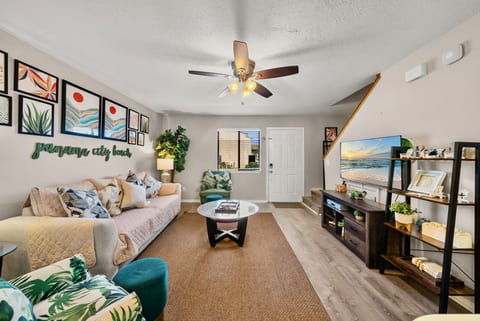 Spacious living room with Smart TV, tropical décor, and plenty of natural light