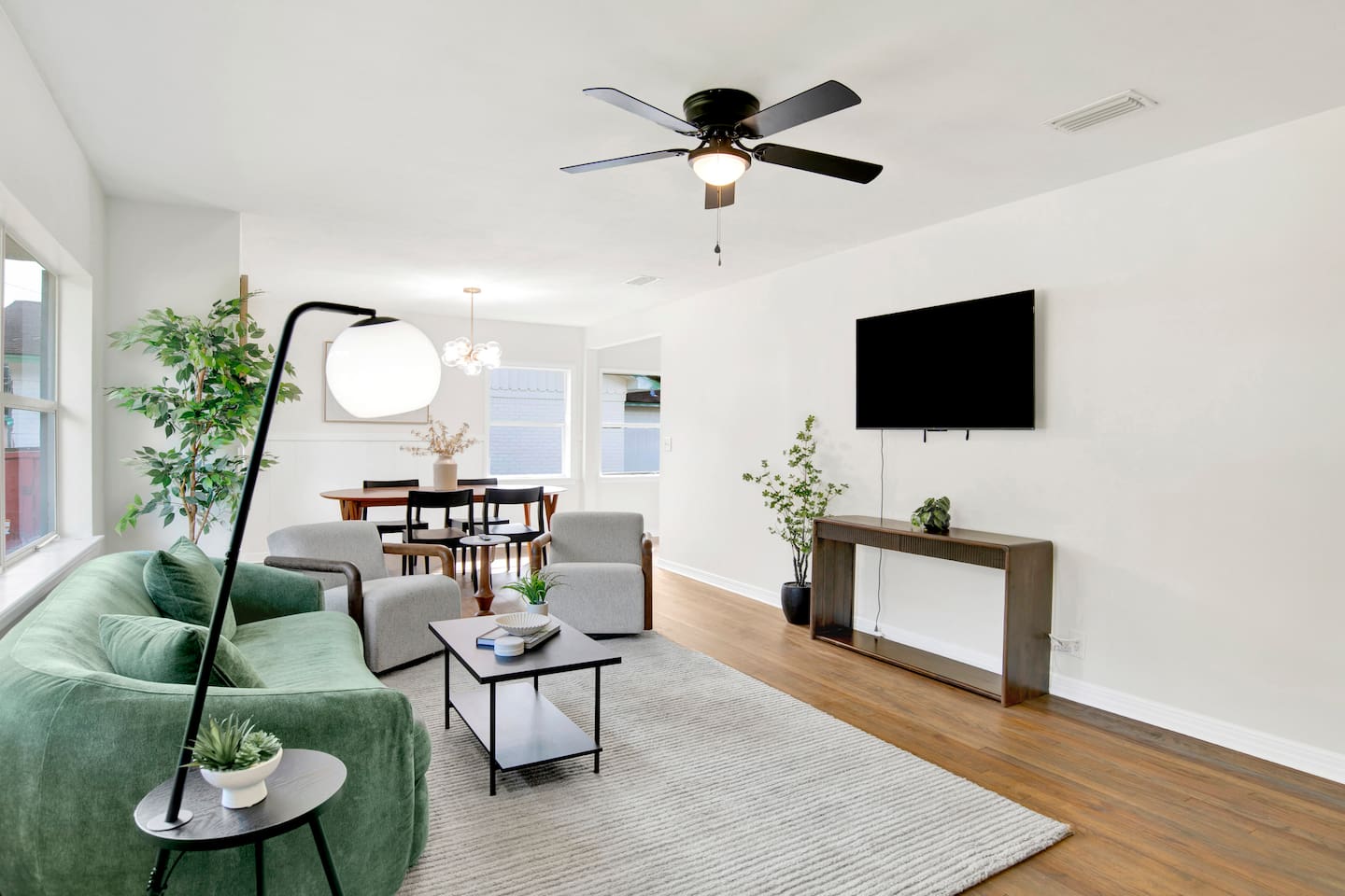 Bright, open living space with plush seating, Smart TV, and plenty of natural light — perfect for relaxing after work.