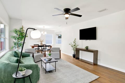Bright, open living space with plush seating, Smart TV, and plenty of natural light — perfect for relaxing after work.