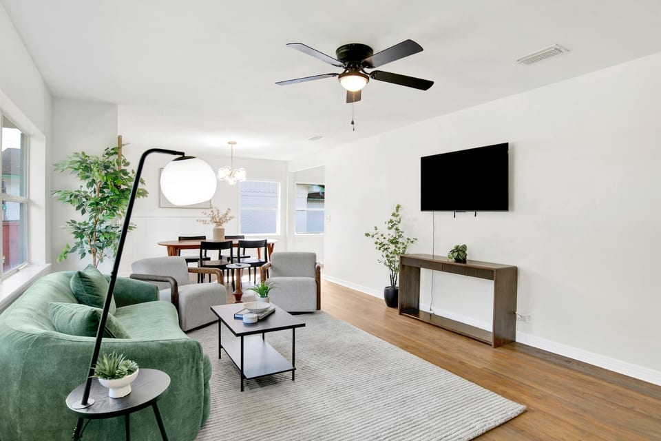 Bright, open living space with plush seating, Smart TV, and plenty of natural light — perfect for relaxing after work.