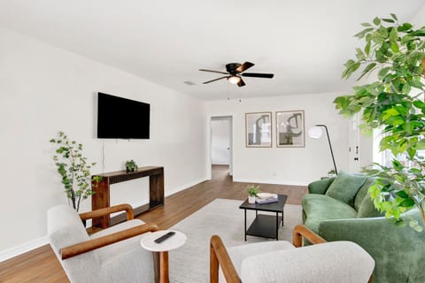 Bright, open living space with plush seating, Smart TV, and plenty of natural light — perfect for relaxing after work.