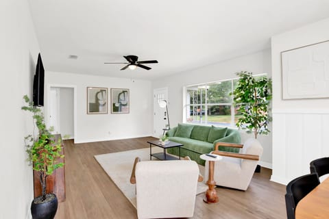 Bright, open living space with plush seating, Smart TV, and plenty of natural light — perfect for relaxing after work.