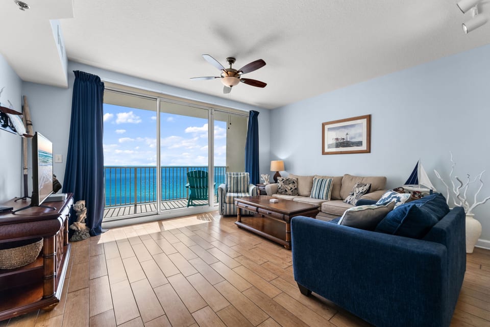 Living Room with Ocean View – Bright living room with floor-to-ceiling windows and breathtaking Gulf panorama.