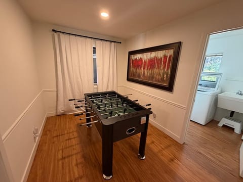 Fun foosball room with stylish decor and convenient nearby laundry