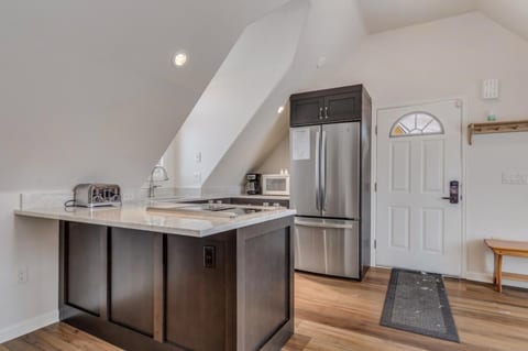 This apartment features a full kitchen with refrigerator, stove top, oven, dishwasher and microwave.