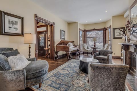 Main living room: Spacious living room makes for a great gathering area - play the piano, drink coffee by the window or warm up by the fire