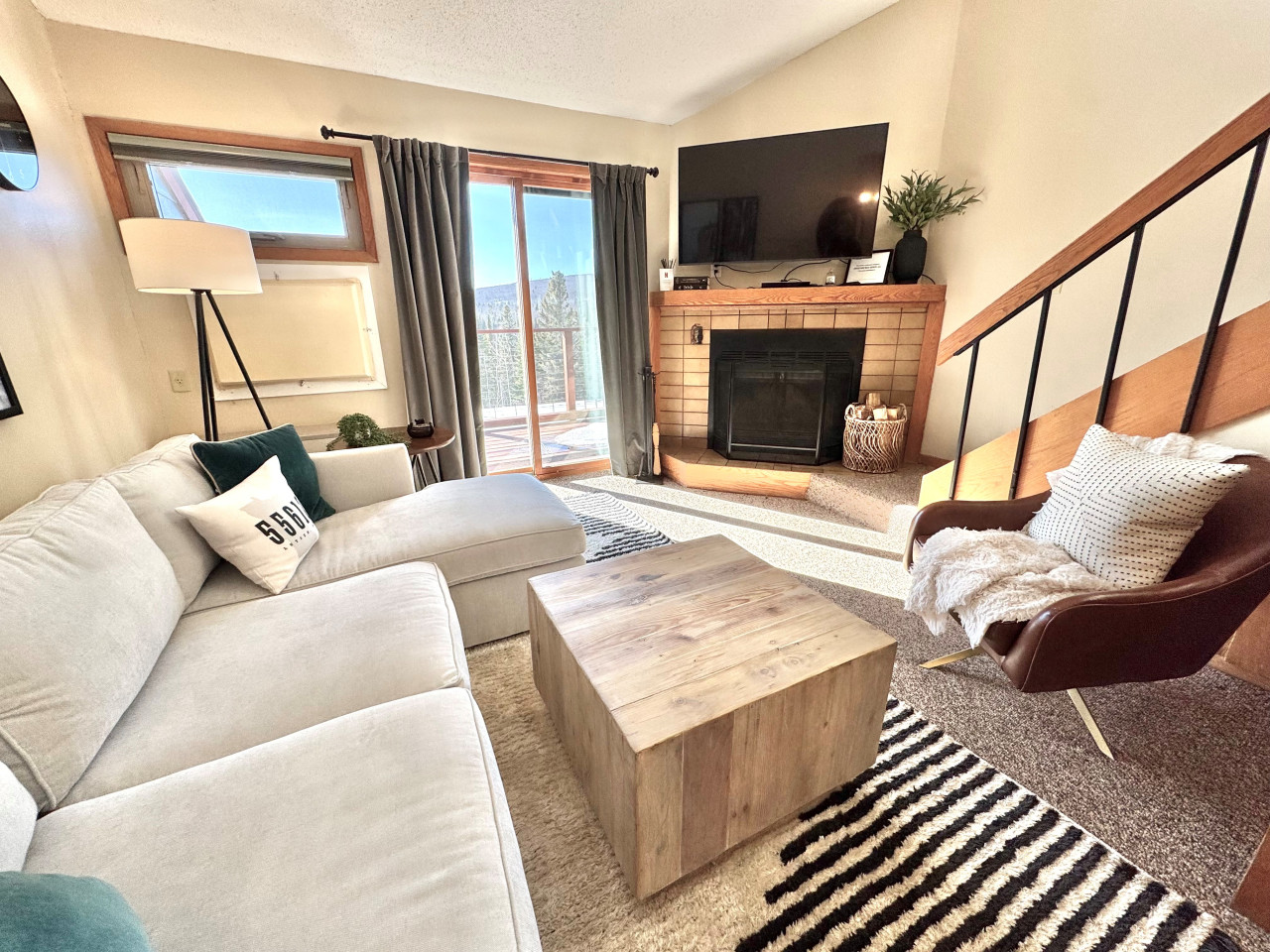 Living Room: Bright and airy space with stunning views, a stylish fireplace, and comfy seating!