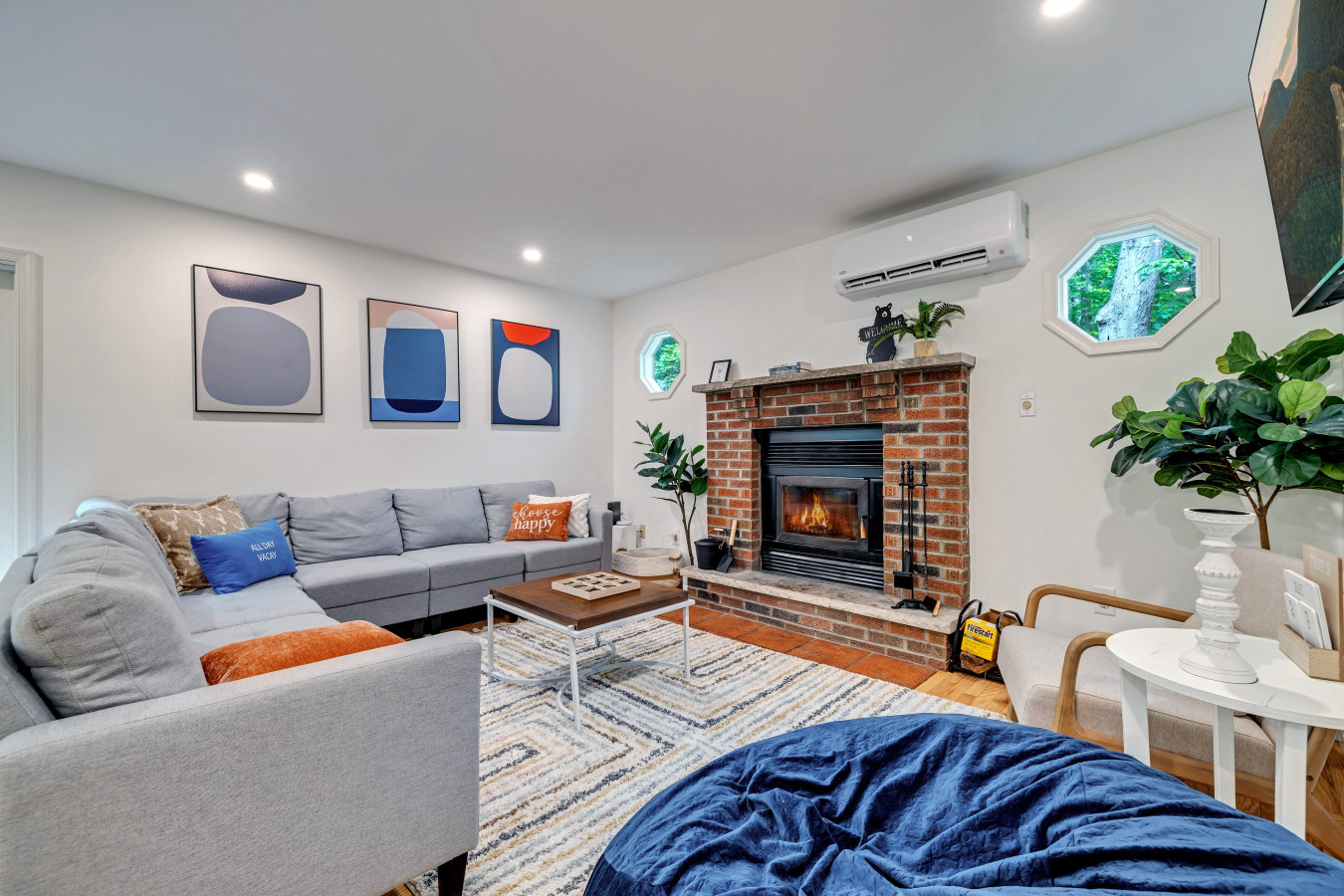 Cozy living room with plenty of seating, a warm fireplace, and a big-screen TV — perfect for movie nights and gatherings.