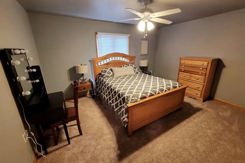 Escape to your cozy, serene bedroom! Unwind in the comfortable queen bed with soft linens. Enjoy the convenient vanity area and ample storage. Your perfect restful retreat awaits!