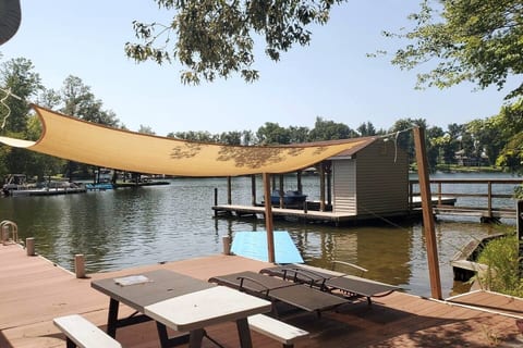 Escape to your private lakeside oasis! Imagine relaxing under the sun sail, enjoying meals on the dock, and soaking up stunning waterfront views. Your perfect getaway awaits!