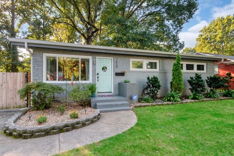Charming mid-century modern home with fresh curb appeal, stylish gray brick, and mature trees - your private retreat just minutes from South End and SouthPark.