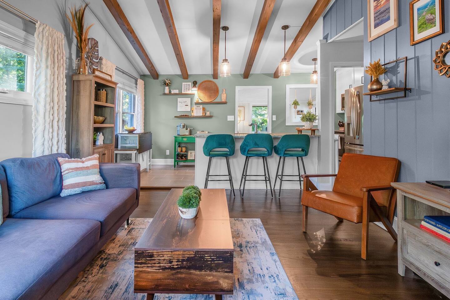 Open-concept living with vaulted ceilings, exposed beams, and designer accents - perfect for relaxing, streaming your favorite shows, or gathering with friends.