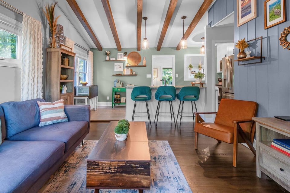 Open-concept living with vaulted ceilings, exposed beams, and designer accents - perfect for relaxing, streaming your favorite shows, or gathering with friends.