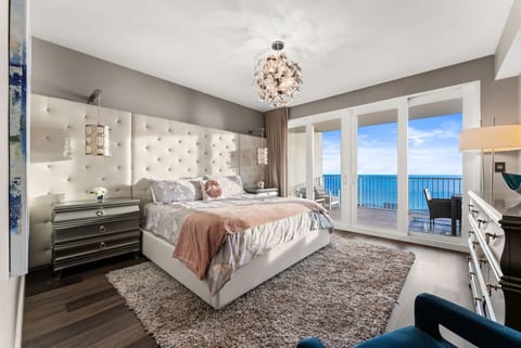 Spacious master suite with a plush king bed and private balcony access overlooking the Gulf.