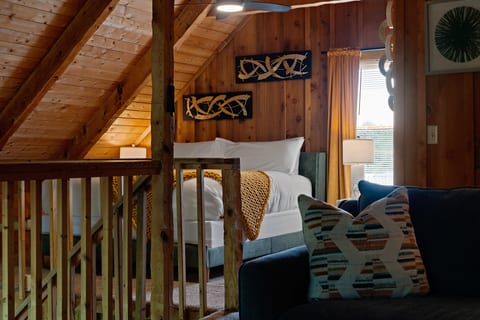Tucked upstairs, the loft at Dancing Embers offers extra sleeping space with sleek, modern mountain-cabin style.