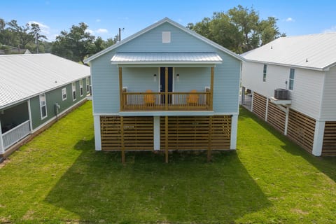 Back of the home with small covered deck